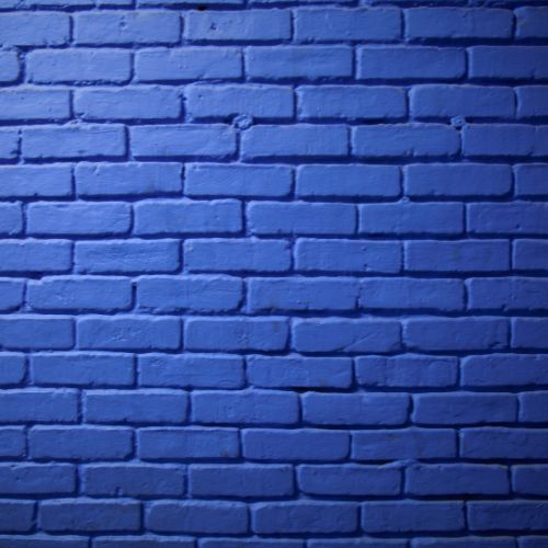 The image shows a close-up view of a blue brick wall with a smooth texture.